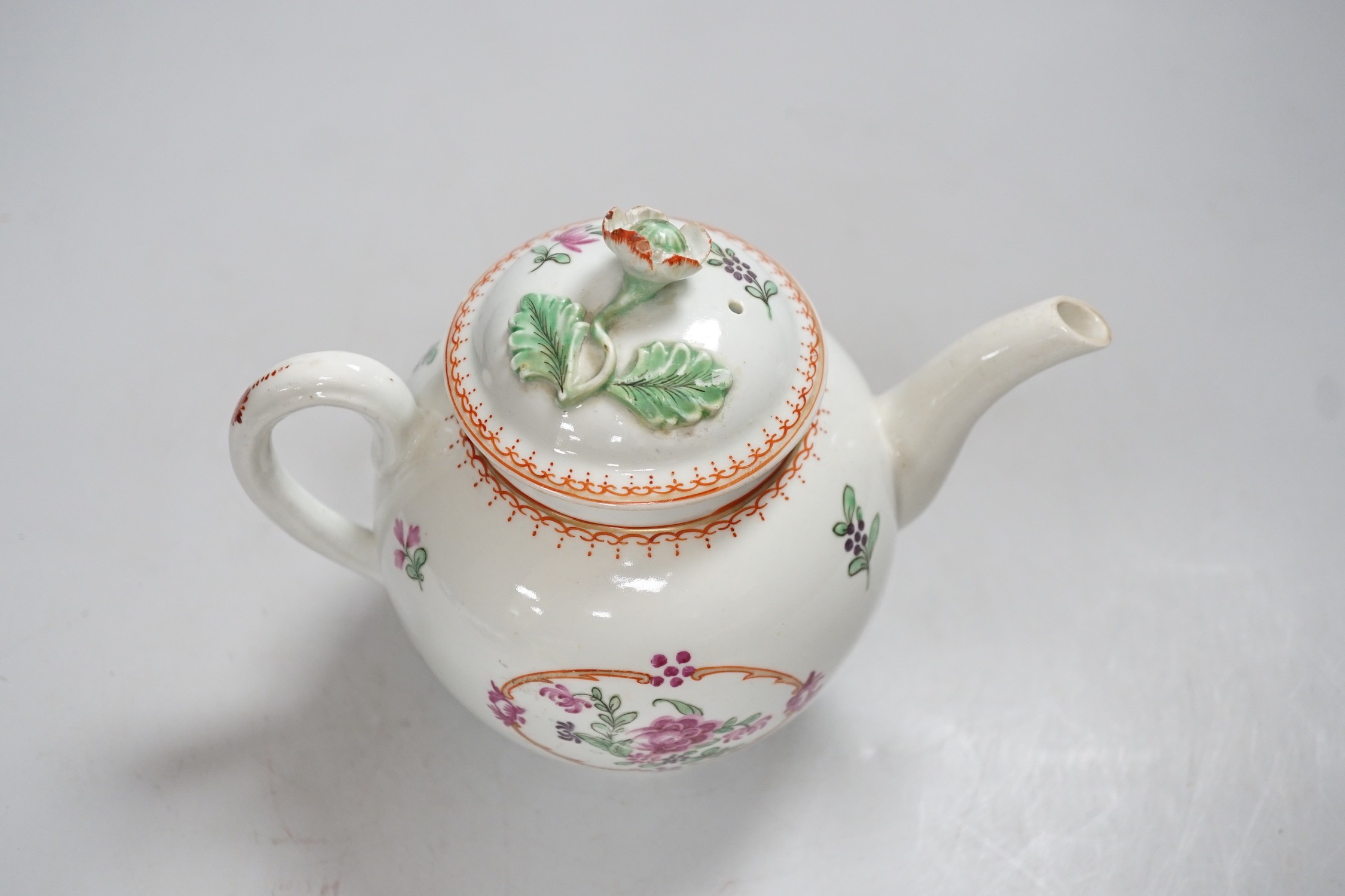 An 18th century Worcester teapot and cover painted in Chinese export style with flowers in an oval panel. 16cm tall